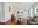 Charming dining room with hardwood floors, decorative wall trim, and modern lighting fixture at 9003 Smokey Hill Ln, Fort Mill, SC 29707