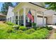 Charming home featuring a covered front porch with an American flag and well-manicured landscaping at 9003 Smokey Hill Ln, Fort Mill, SC 29707