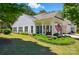 Beautiful curb appeal of a home featuring a cozy front porch with an American flag and lush green lawn at 9003 Smokey Hill Ln, Fort Mill, SC 29707