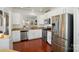 Modern kitchen with stainless steel appliances, white cabinets and a breakfast bar at 9003 Smokey Hill Ln, Fort Mill, SC 29707