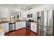 Well-lit kitchen with stainless steel appliances, granite countertops, and updated white cabinets at 9003 Smokey Hill Ln, Fort Mill, SC 29707
