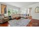 Bright and airy living room with ample natural light, comfortable seating, and hardwood floors at 9003 Smokey Hill Ln, Fort Mill, SC 29707