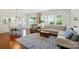 Cozy living room with open dining area, large windows, and hardwood floors at 9003 Smokey Hill Ln, Fort Mill, SC 29707