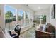 Bright sunroom with many windows, comfortable seating, and views of the backyard at 9003 Smokey Hill Ln, Fort Mill, SC 29707