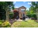 Well-manicured backyard with patio seating, landscaping, and lush green lawn at 9735 Wheatfield Rd, Charlotte, NC 28277
