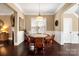 Cozy dining area with a game table, hardwood floors and a door that leads to the entryway at 9735 Wheatfield Rd, Charlotte, NC 28277