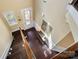 Bright foyer with hardwood floors, staircase, and decorative accents creating a welcoming entrance at 9735 Wheatfield Rd, Charlotte, NC 28277