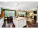 Kitchen island with granite counters is the central gathering place within the open-concept kitchen and living area at 9735 Wheatfield Rd, Charlotte, NC 28277