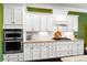 Modern kitchen with white cabinetry, granite countertops, stainless steel appliances, and a gas cooktop at 9735 Wheatfield Rd, Charlotte, NC 28277