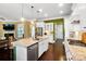 Open-concept kitchen featuring an island with seating, stainless steel appliances, and hardwood floors at 9735 Wheatfield Rd, Charlotte, NC 28277