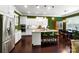 Modern kitchen featuring stainless steel appliances, a center island with seating, and contrasting green walls at 9735 Wheatfield Rd, Charlotte, NC 28277