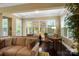 Bright living room features a comfortable couch and an office nook with natural light from large windows at 9735 Wheatfield Rd, Charlotte, NC 28277