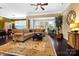 Open-concept living room with ceiling fan, hardwood floors, a large rug, and seamless flow to adjacent spaces at 9735 Wheatfield Rd, Charlotte, NC 28277
