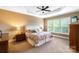 Serene main bedroom with a ceiling fan, carpet, and plenty of natural light at 9735 Wheatfield Rd, Charlotte, NC 28277