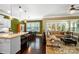 Bright open-concept area with a kitchen island, dining space, and a living area with large windows for natural light at 9735 Wheatfield Rd, Charlotte, NC 28277