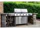 Built-in outdoor grill with a stainless steel finish and stone surround, perfect for outdoor cooking at 9735 Wheatfield Rd, Charlotte, NC 28277