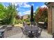 Backyard patio featuring an umbrella, table, chairs, grill, and lush landscaping at 9735 Wheatfield Rd, Charlotte, NC 28277