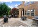 Cozy backyard patio with ample seating, grill, and charming brick exterior of the home at 9735 Wheatfield Rd, Charlotte, NC 28277