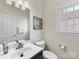 Stylish half bathroom featuring a modern vanity, framed mirror, and bright natural light at 9923 Paradise Ridge Rd, Charlotte, NC 28277