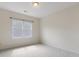 Simple and neutral bedroom with a large window at 9923 Paradise Ridge Rd, Charlotte, NC 28277