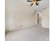 Bright bonus room featuring a ceiling fan, neutral carpet and paint and steps leading up at 9923 Paradise Ridge Rd, Charlotte, NC 28277