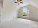 Sunlit bonus room with neutral carpet, large window, and ample space for activities at 9923 Paradise Ridge Rd, Charlotte, NC 28277