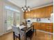 Bright dining area adjacent to the kitchen with outdoor access and built-in cabinets at 9923 Paradise Ridge Rd, Charlotte, NC 28277