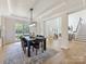 Open concept dining area featuring a stylish light fixture and seamless flow into the living spaces at 9923 Paradise Ridge Rd, Charlotte, NC 28277