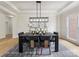 Elegant dining room featuring a modern chandelier, stylish decor, and ample seating at 9923 Paradise Ridge Rd, Charlotte, NC 28277