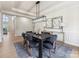 Elegant dining room featuring a modern chandelier, stylish decor, and ample seating at 9923 Paradise Ridge Rd, Charlotte, NC 28277