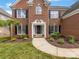 Charming two-story brick home with manicured lawn and inviting front entrance at 9923 Paradise Ridge Rd, Charlotte, NC 28277