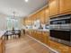 Well-equipped kitchen with stainless steel appliances, tiled backsplash, and adjacent dining area at 9923 Paradise Ridge Rd, Charlotte, NC 28277