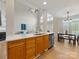 Open kitchen featuring quartz countertops, stainless steel appliances, and a breakfast bar area at 9923 Paradise Ridge Rd, Charlotte, NC 28277