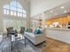 Spacious living room with high ceilings, large windows, hardwood floors, and comfortable seating at 9923 Paradise Ridge Rd, Charlotte, NC 28277
