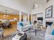 Bright, open living room features a fireplace, hardwood floors, and seamless access to the kitchen at 9923 Paradise Ridge Rd, Charlotte, NC 28277