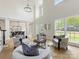 Bright, open living room with soaring ceilings, modern furniture, and a view of the dining area at 9923 Paradise Ridge Rd, Charlotte, NC 28277