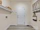 The mud room has coat hooks and shelf with baskets at 9923 Paradise Ridge Rd, Charlotte, NC 28277