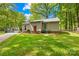 The rear exterior of the house features a red door and a well-maintained lawn at 10200 Cairnsmore Pl # 9, Mint Hill, NC 28227