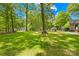 Spacious backyard with mature trees, offering plenty of room for recreation and enjoying nature at 10200 Cairnsmore Pl # 9, Mint Hill, NC 28227