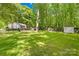 Expansive backyard with lush green grass, mature trees, and ample space for outdoor activities and relaxation at 10200 Cairnsmore Pl # 9, Mint Hill, NC 28227