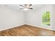 Bright, spacious bedroom with a large window offering lots of natural light and wood-look flooring at 10200 Cairnsmore Pl # 9, Mint Hill, NC 28227