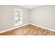 Cozy bedroom features a window and wood-look flooring, perfect for relaxation at 10200 Cairnsmore Pl # 9, Mint Hill, NC 28227