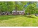 Beautiful home with a large green lawn and lush trees, offering a serene and inviting curb appeal at 10200 Cairnsmore Pl # 9, Mint Hill, NC 28227