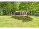 Charming home nestled among trees, featuring a lush green lawn and inviting landscaping at 10200 Cairnsmore Pl # 9, Mint Hill, NC 28227