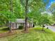 Quaint home with mature landscaping, showcasing a well-maintained lawn and verdant trees at 10200 Cairnsmore Pl # 9, Mint Hill, NC 28227