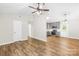 Open-concept living room featuring wood-look floors and access to kitchen and front door at 10200 Cairnsmore Pl # 9, Mint Hill, NC 28227