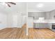 Open-concept living room flowing into kitchen with gray cabinets and modern appliances at 10200 Cairnsmore Pl # 9, Mint Hill, NC 28227