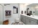 Modern bathroom features double vanity, a framed mirror, neutral colors, and a shower with glass doors at 1023 Hostler Ln, York, SC 29745