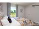 Bedroom featuring a window view, stylish bedding, and bright lighting, enhancing the room's appeal at 1023 Hostler Ln, York, SC 29745
