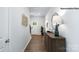 Inviting hallway with wood floors, stylish console table, decorative mirror, and a view of the front door at 1023 Hostler Ln, York, SC 29745